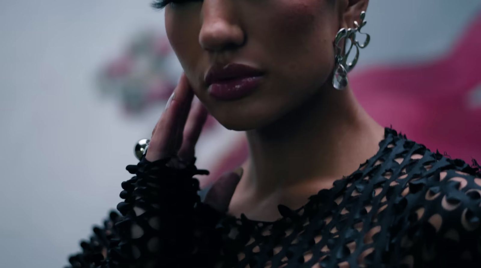 a close up of a person wearing earrings