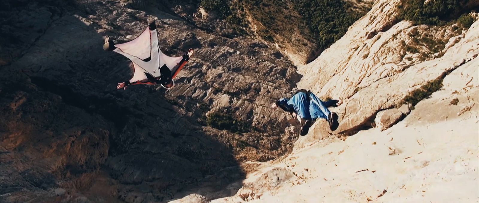 a man flying through the air while riding a kite