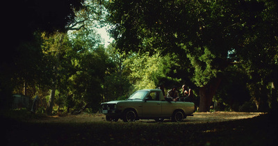 a pick up truck parked in a wooded area