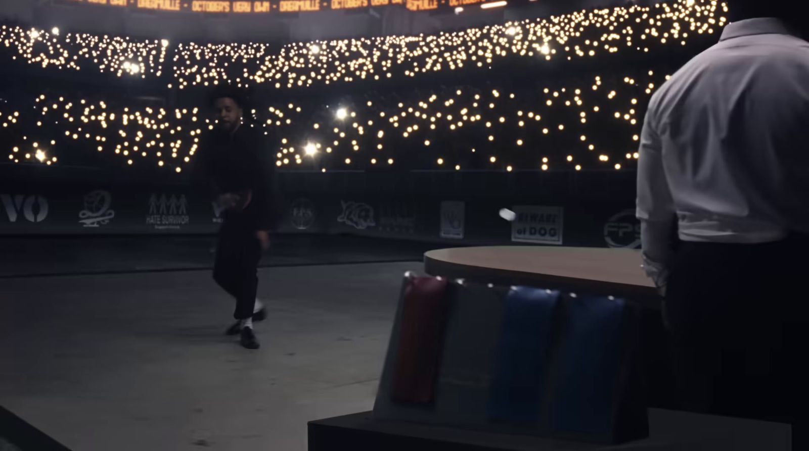 a man standing in front of a stage with lights on it