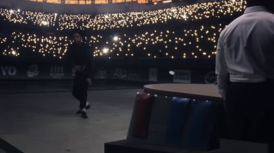 a man standing in front of a stage with lights on it