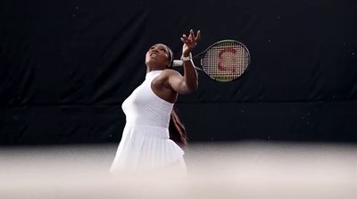 a woman holding a tennis racquet on a tennis court