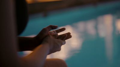 a person sitting in front of a swimming pool