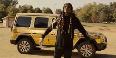 a man standing in front of a yellow jeep