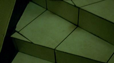 a person standing on a tiled floor next to a wall