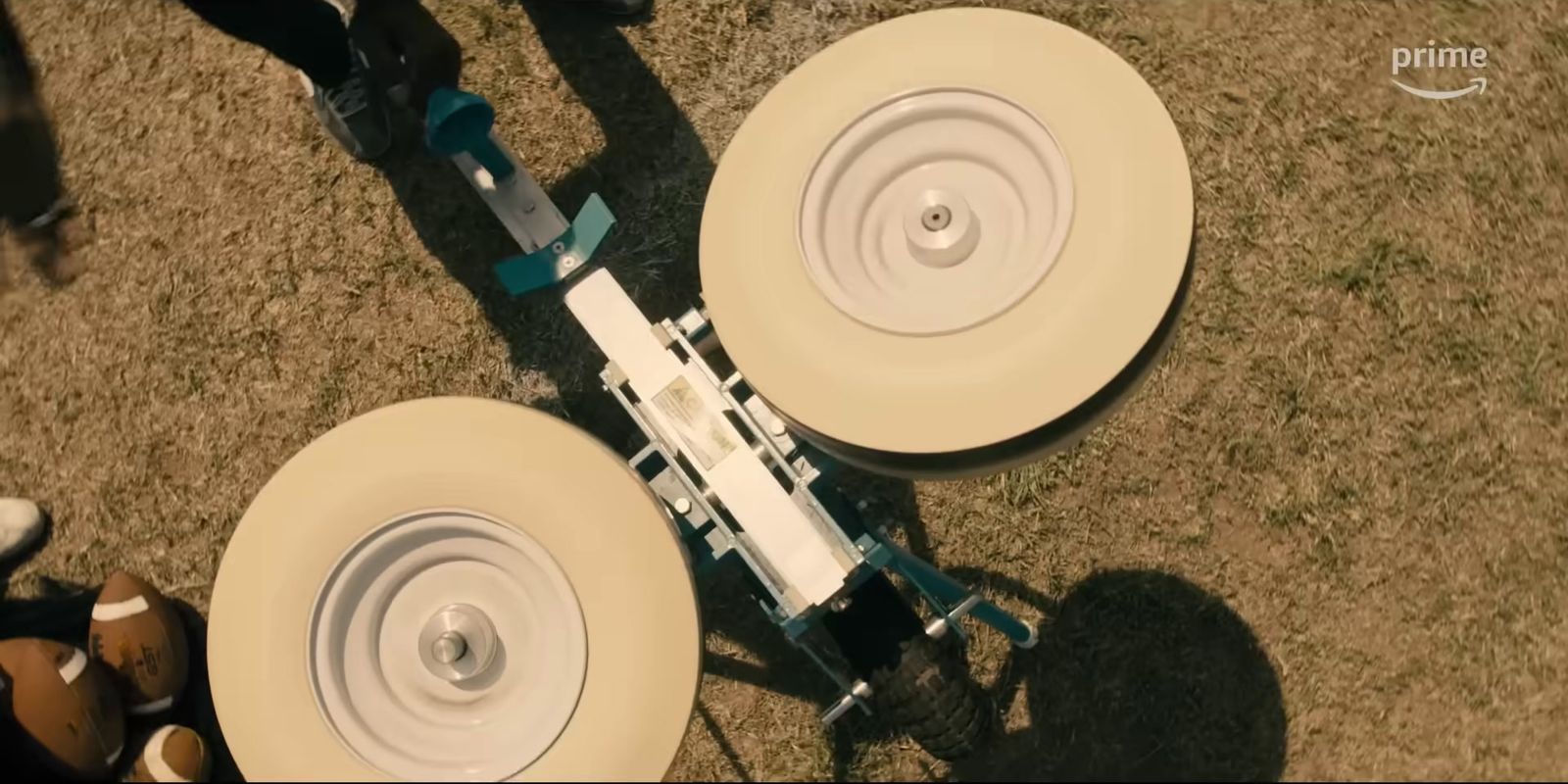 a couple of white wheels sitting on top of a grass covered field