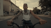 a man riding a bike down a street