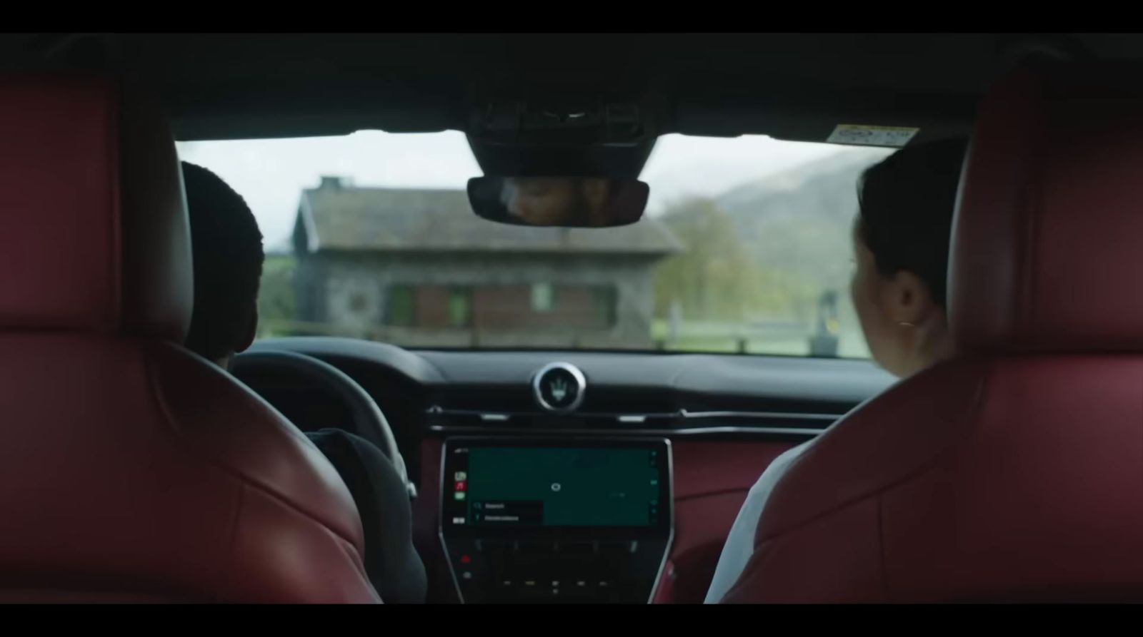 a man sitting in a car looking at a monitor