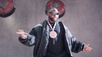 a man in a black jacket and a medal around his neck