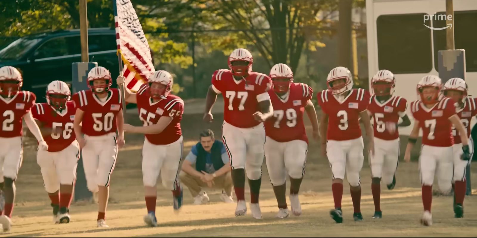 a group of football players walking down a field