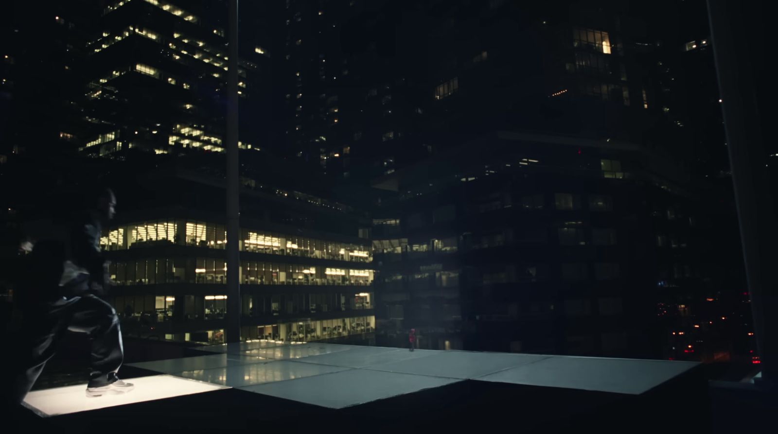 a person standing on top of a roof at night