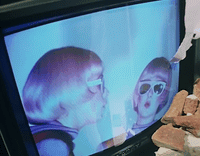 a television screen with a picture of two women on it