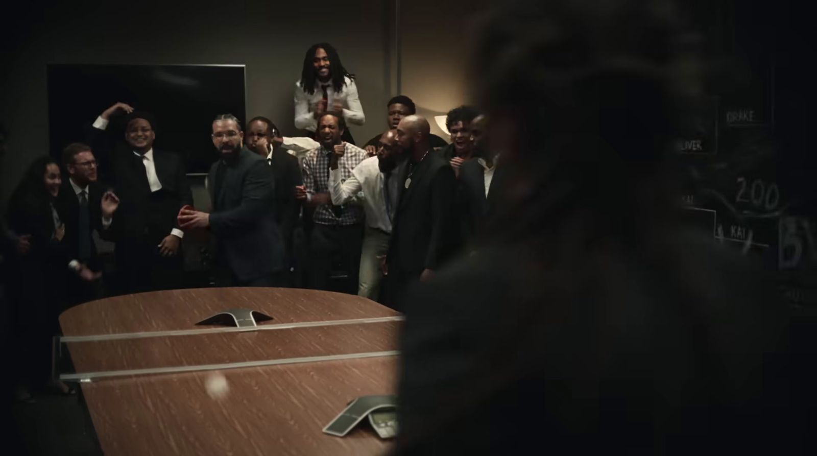 a group of people standing around a wooden table