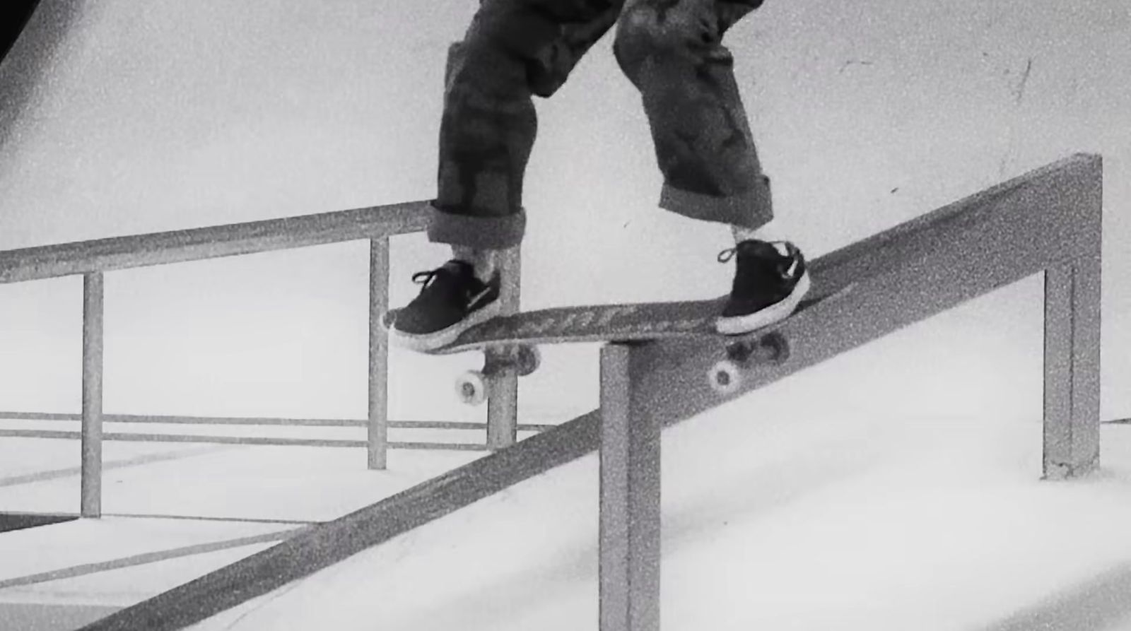 a person riding a skate board on a rail