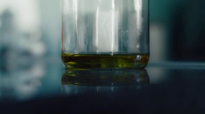 a close up of a bottle of liquid on a table