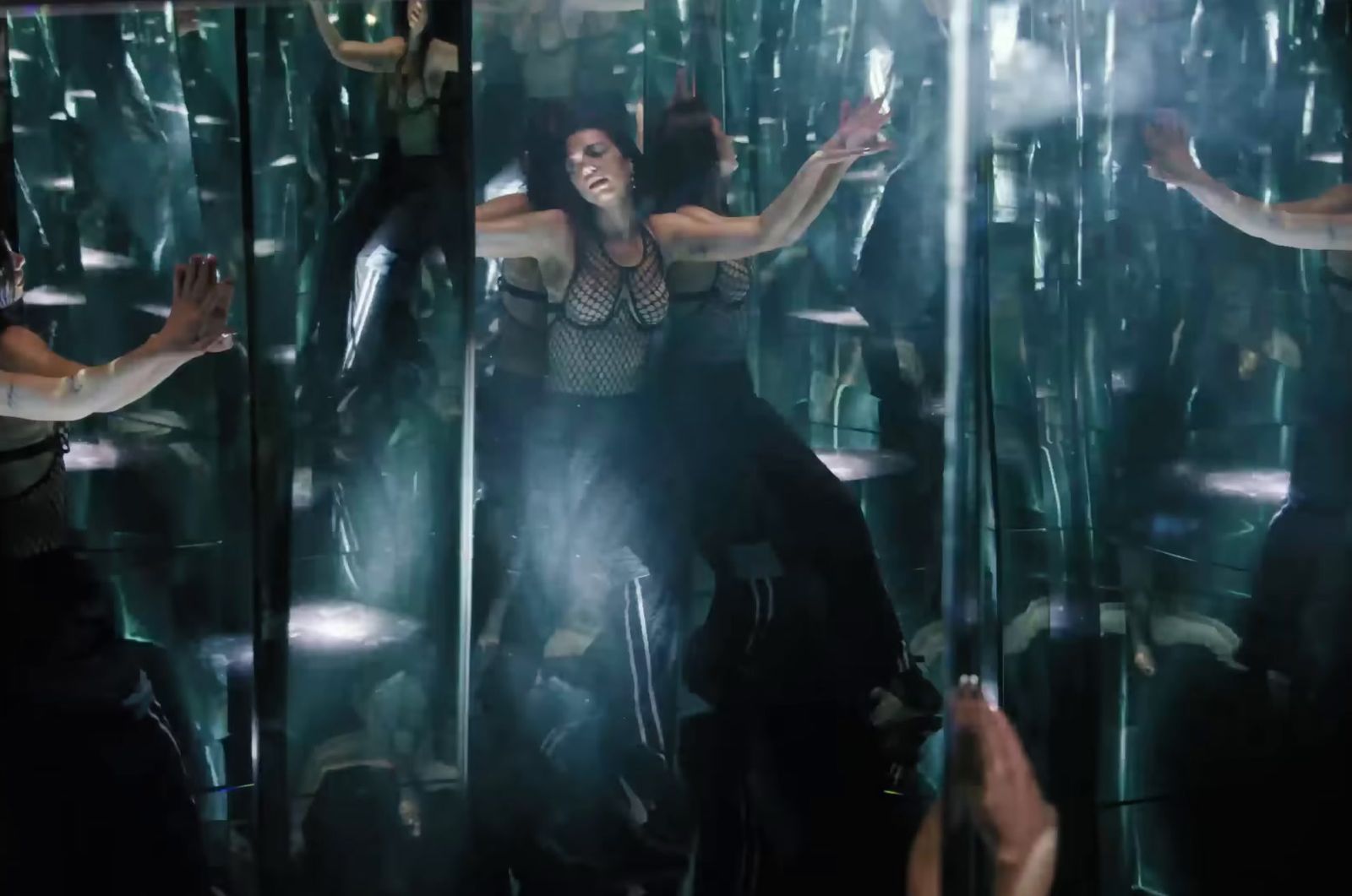 a woman is dancing in a mirrored room