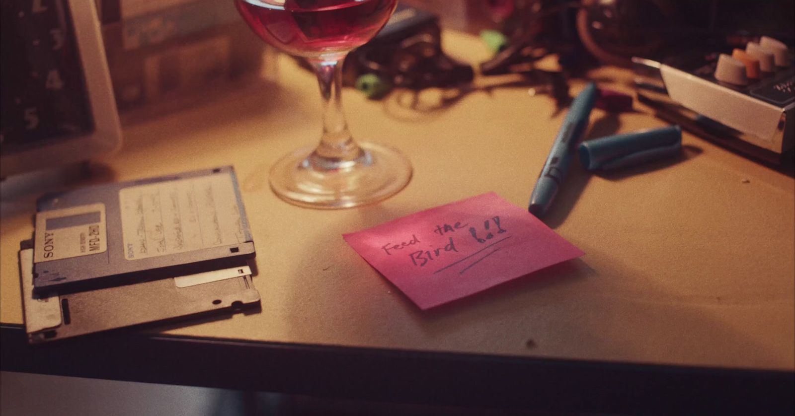 a glass of wine sitting on top of a table