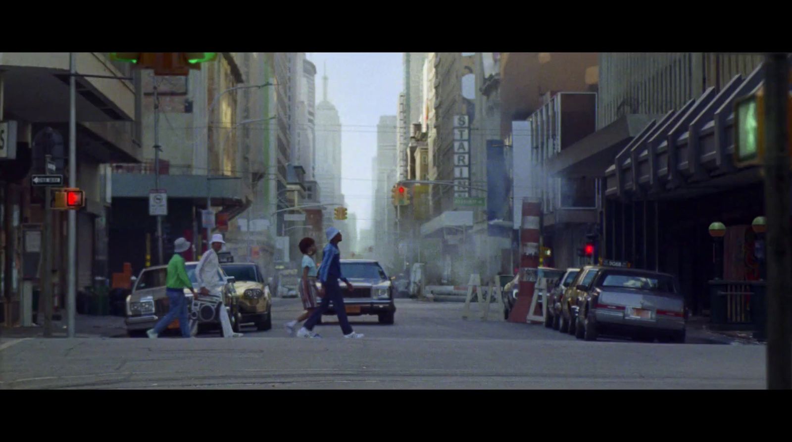 a group of people walking across a street