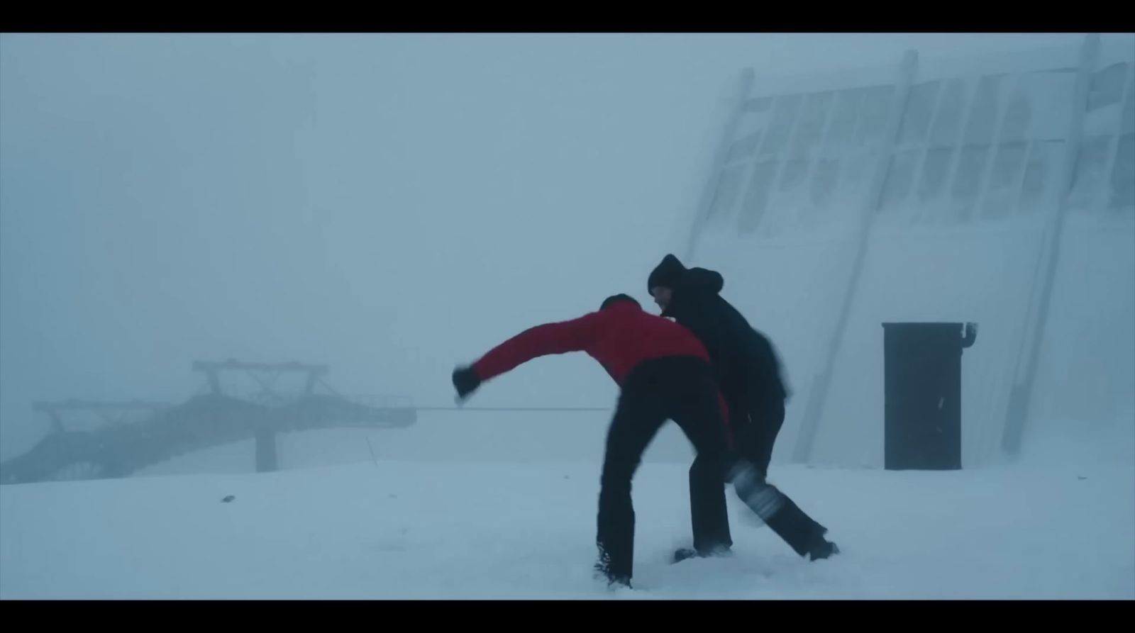 a couple of people riding skis down a snow covered slope