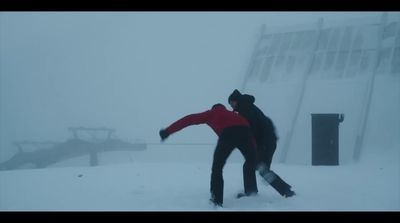 a couple of people riding skis down a snow covered slope