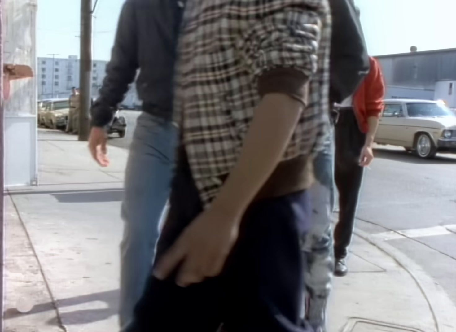 a man riding a skateboard down a sidewalk