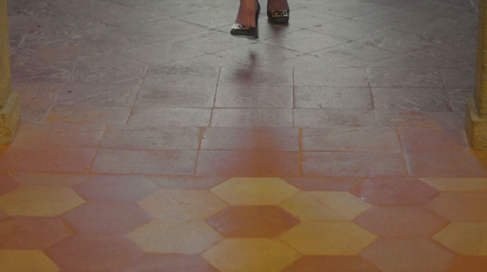 a woman walking down a street holding an umbrella