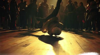 a person doing a handstand on a wooden floor