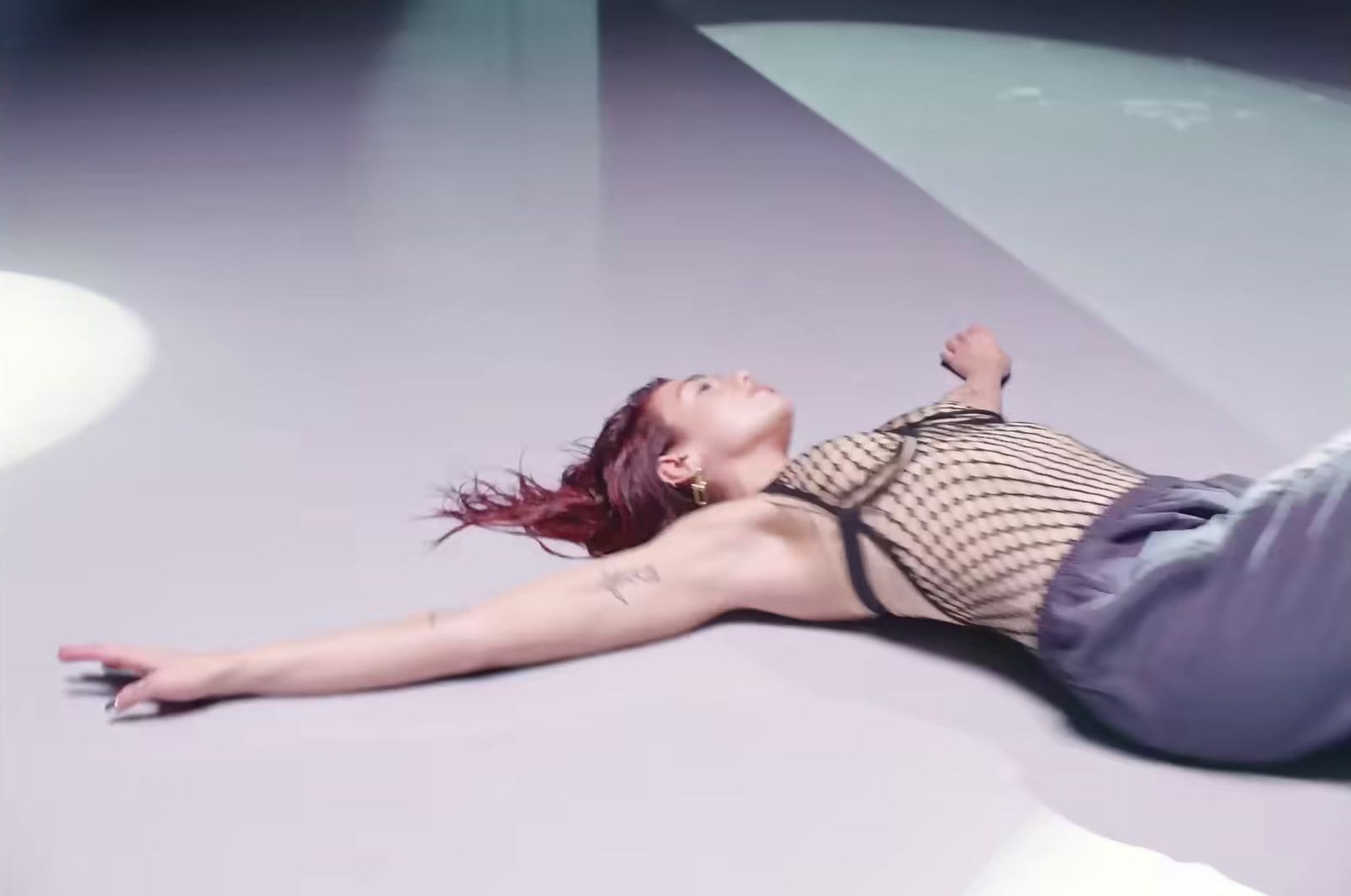 a woman laying on the ground with her legs spread out