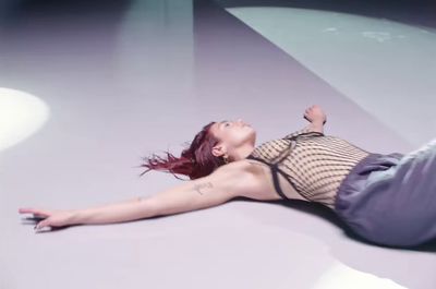 a woman laying on the ground with her legs spread out