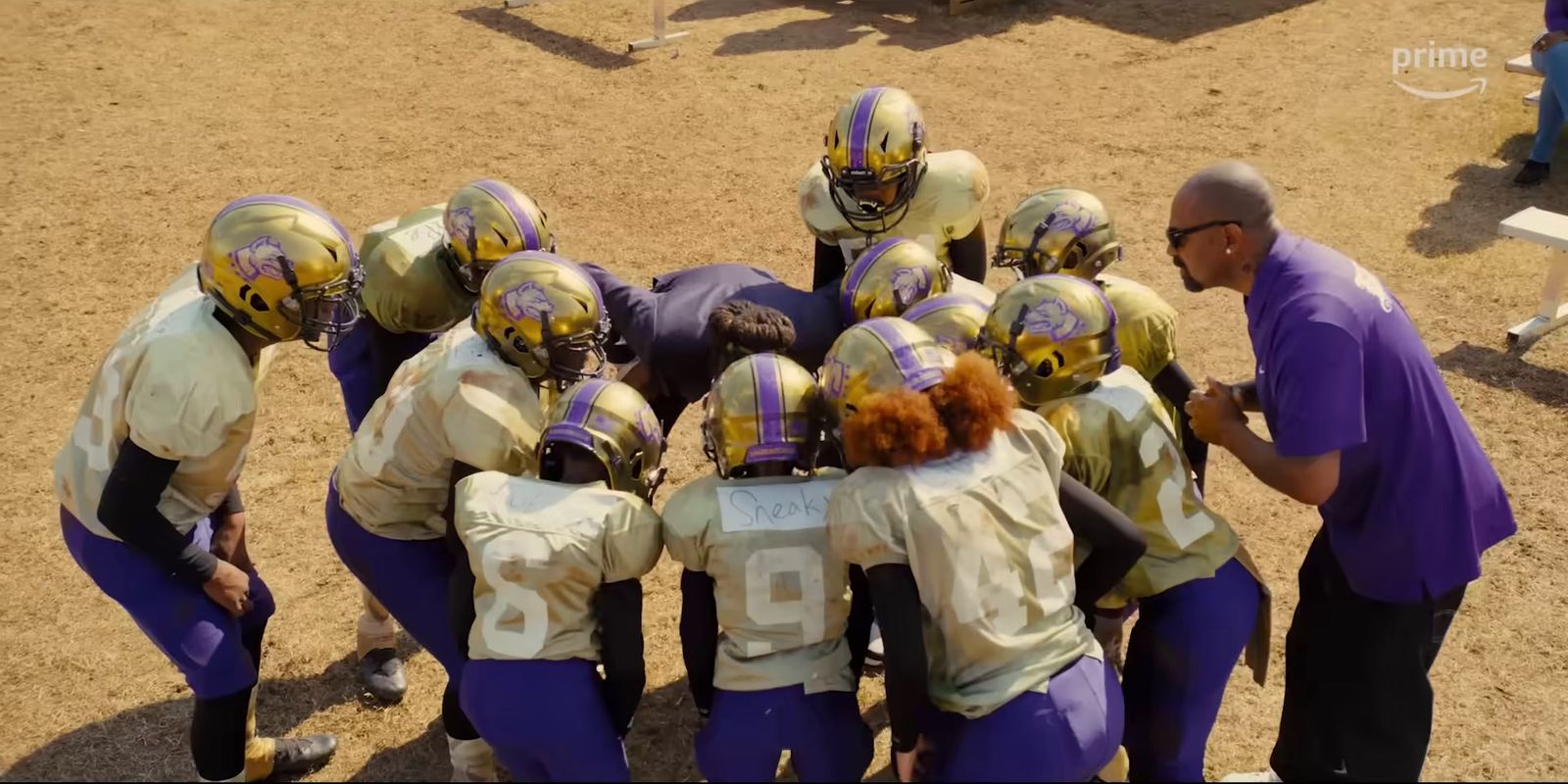 a group of football players huddled in a huddle