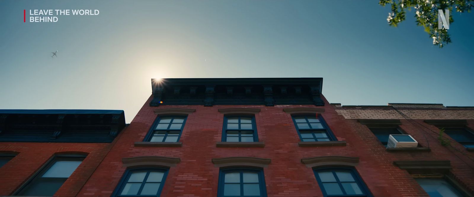 a red brick building with the sun shining through the windows