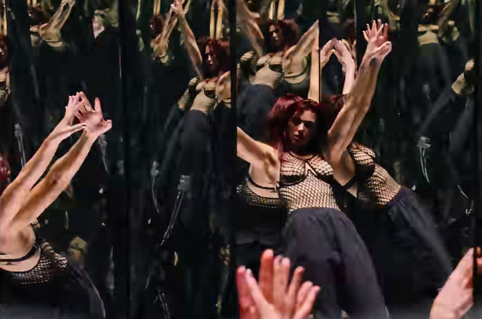 a woman with red hair is dancing in front of a group of people