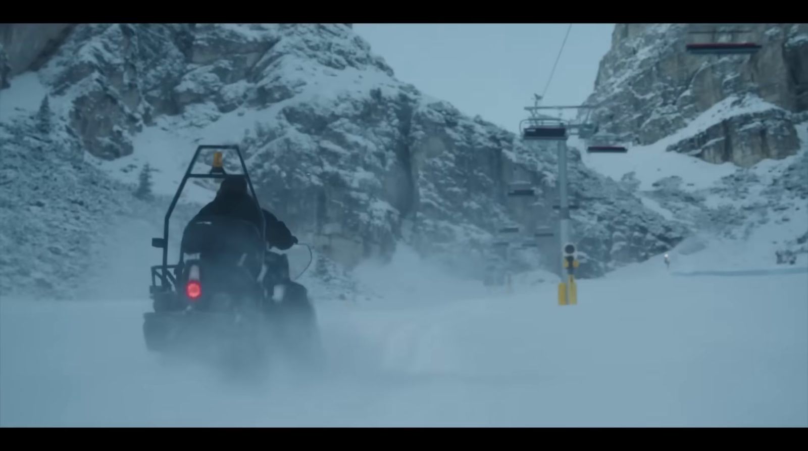 a person riding a snowmobile in the snow