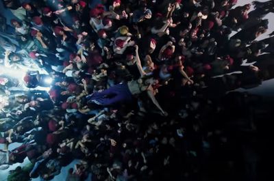 a large group of people standing in the middle of a room