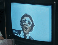 a television with a picture of a man wearing sunglasses