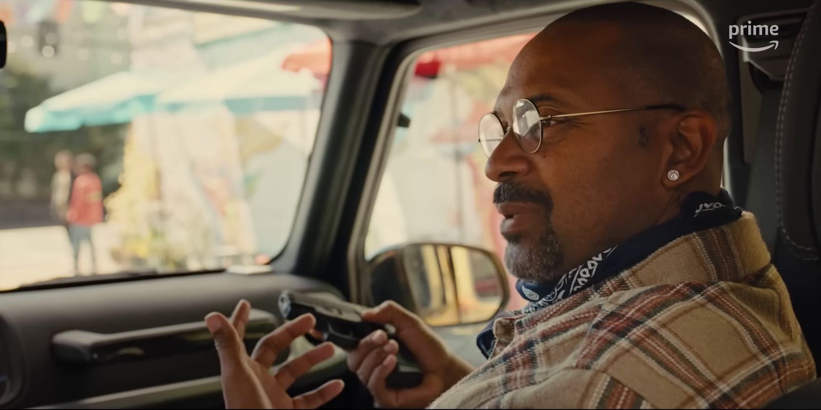 a man sitting in a car holding a cell phone