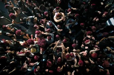 a large group of people standing around each other