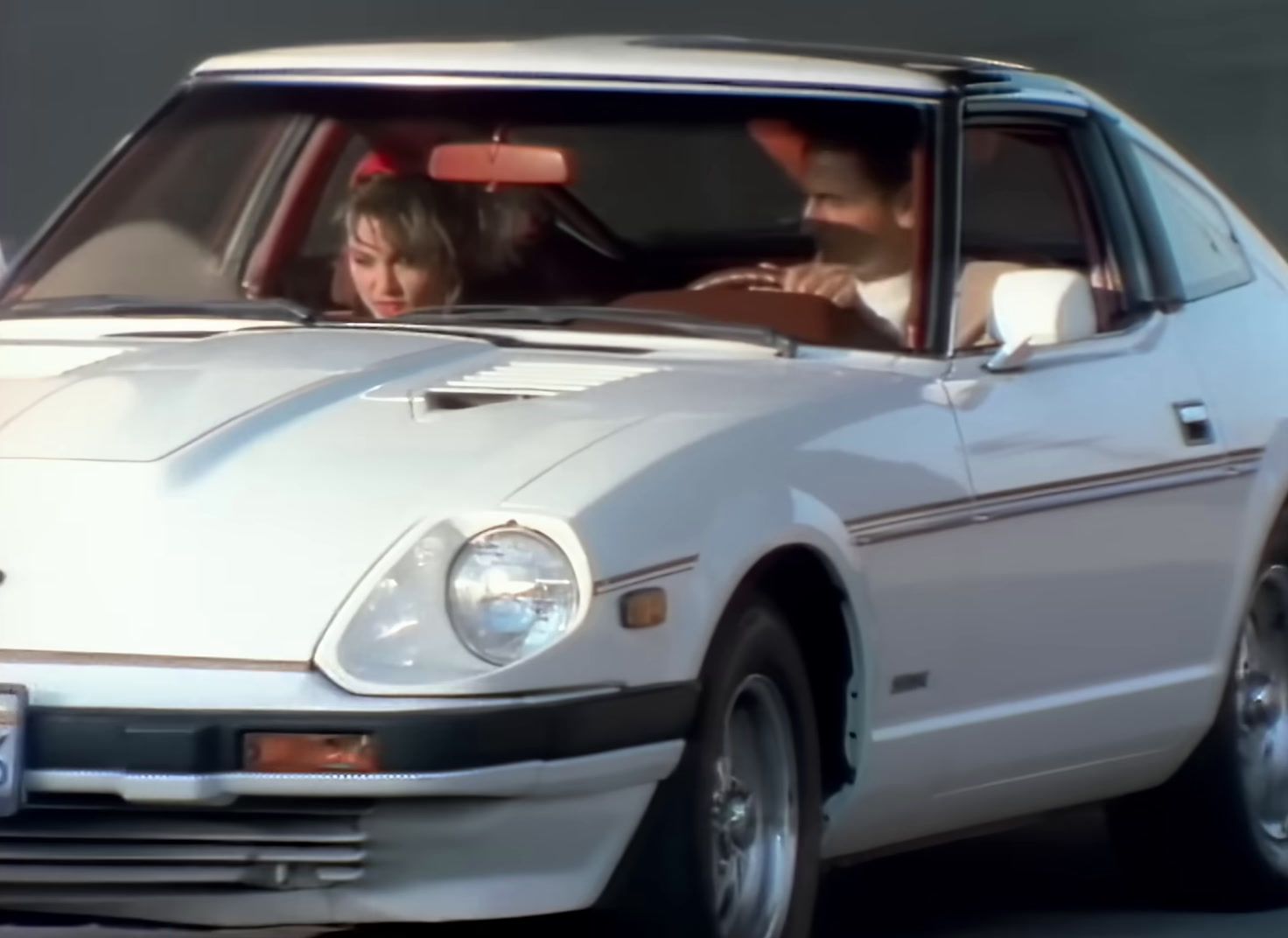 a man and a woman in a white car