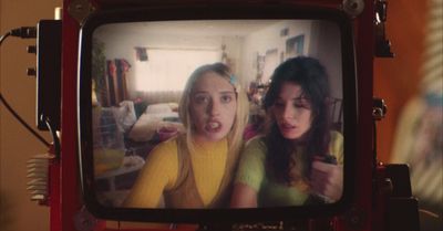 two young women are on a television screen