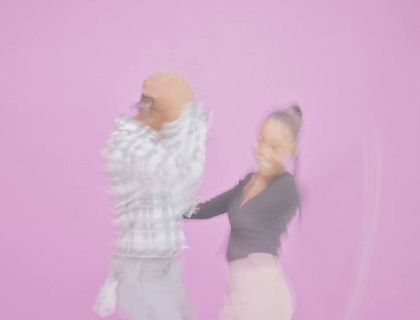 a blurry image of a man and a woman dancing