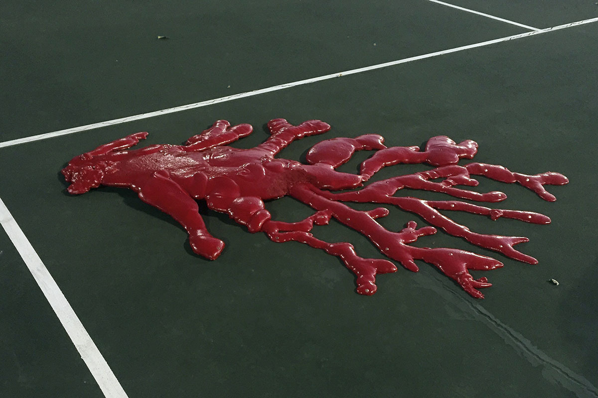 a tennis court with a red substance on it