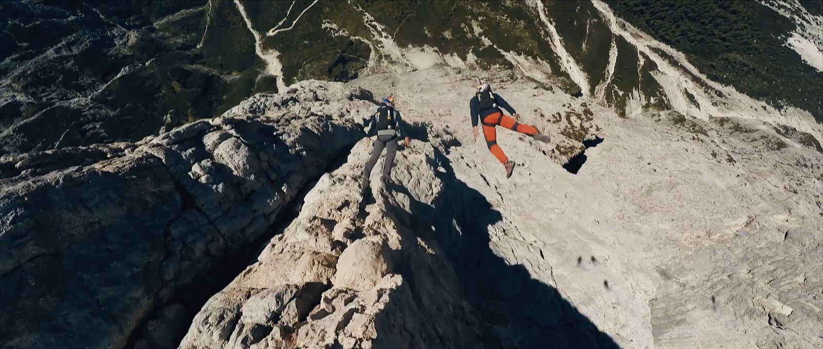 a man climbing up the side of a mountain