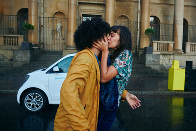 a man and a woman kissing in the rain