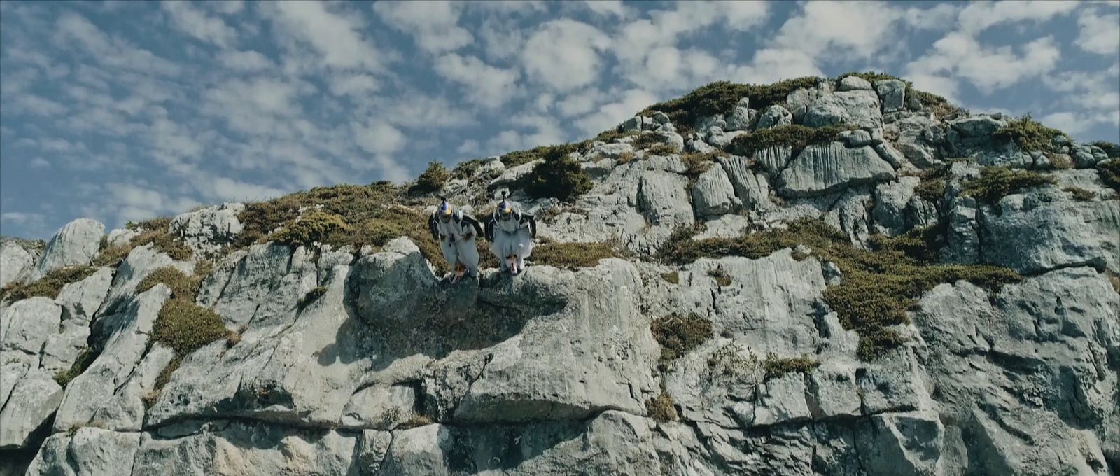 a group of people standing on top of a mountain