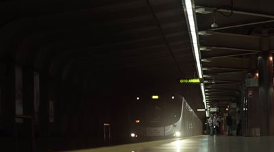 a train pulling into a train station at night