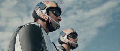 a couple of men wearing helmets standing next to each other