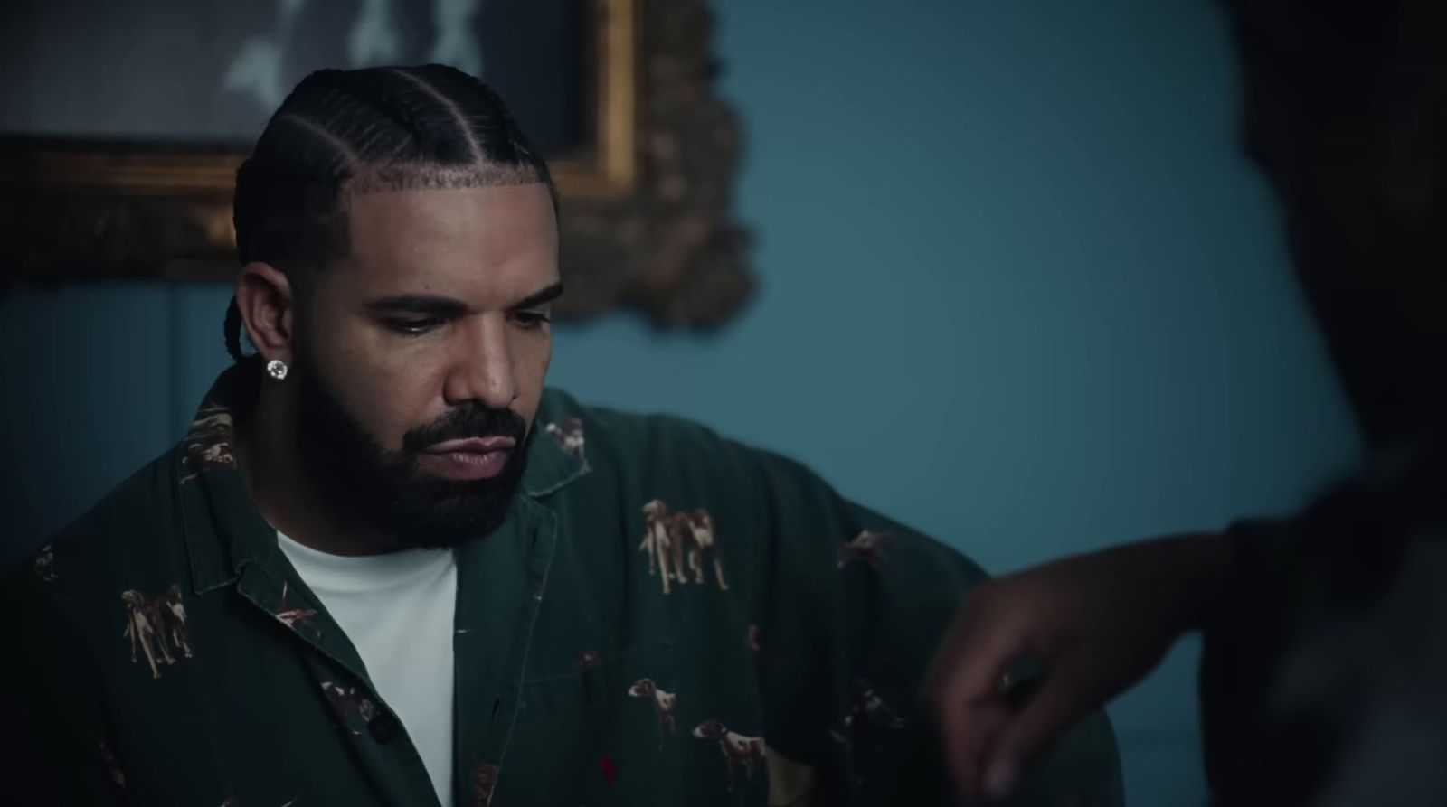 a man with a pony tail in a room