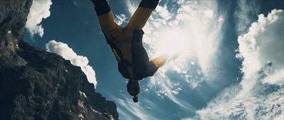 a man flying through the air while riding a snowboard