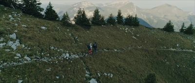 a couple of people walking up a hill