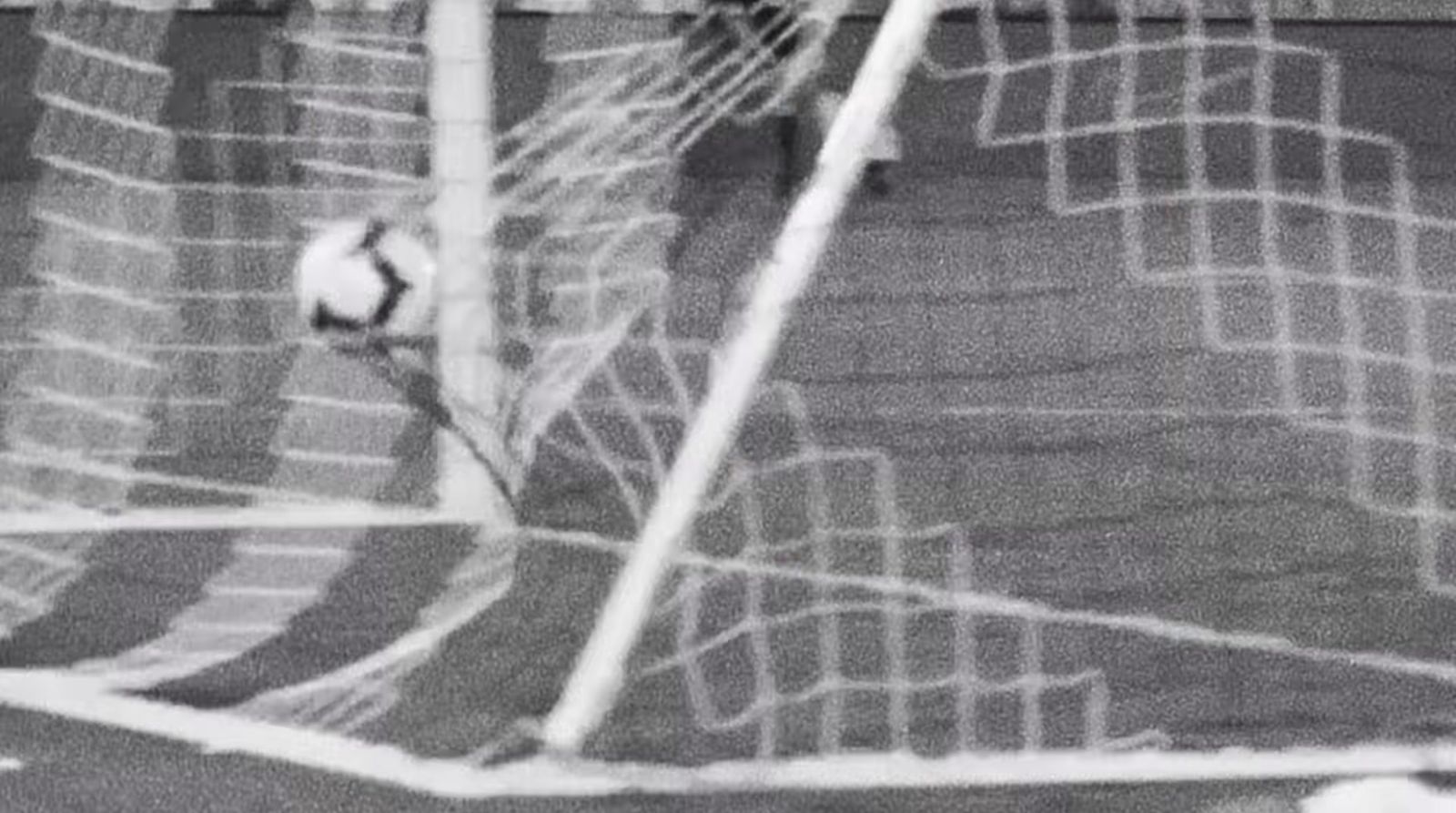 a soccer goalie has his head in the net